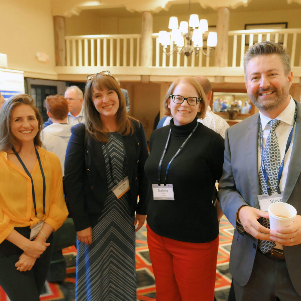 4 attendees of the Permian event standing side by side.
