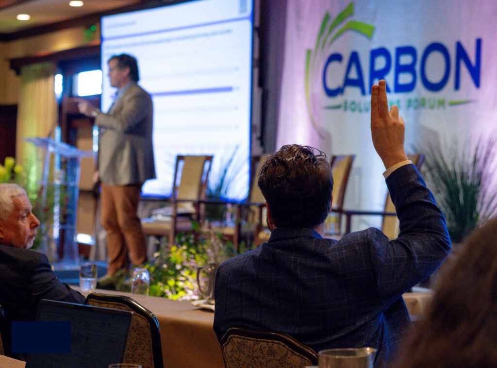 Attendee raising his hand during a speaker talk.