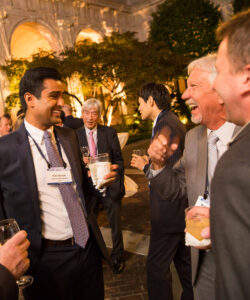 Group of attendees laughing together outside after an event.