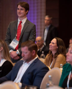 Audience member standing up during an event.