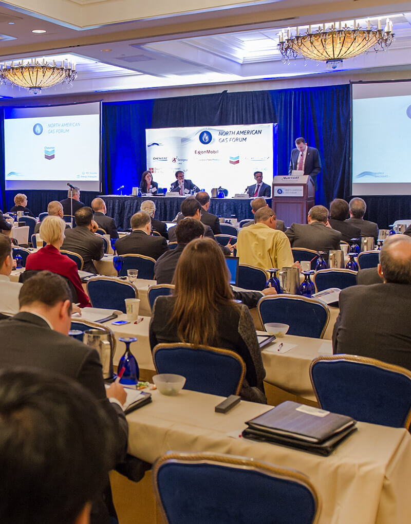 Attendees watching presentation on stage.